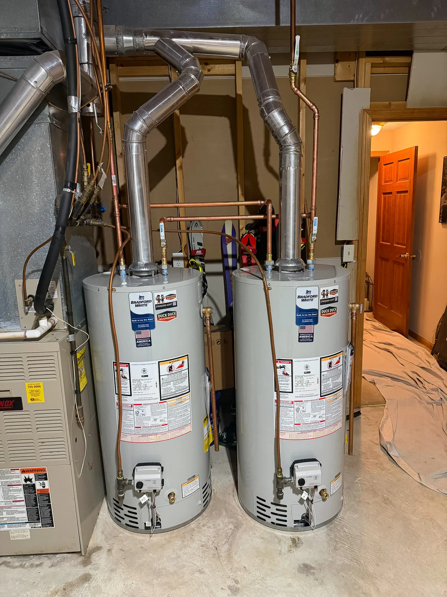 Two new Bradford White water heaters installed side by side